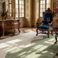 Luxurious room with ornate furniture, including a chair with a blue cushion and gold emblem.