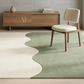 Rug with wavy design in a room with wooden furniture and a chair.