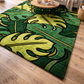 Green and yellow leaf-patterned rug on a wooden floor