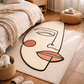 Abstract face rug on a wooden floor in a bedroom setting