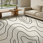 Modern living room with a patterned rug, sofa, and coffee table.