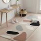 Modern room with a patterned rug, wooden table, and decor items.