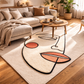 Living room with a modern rug featuring abstract design, sofa, and coffee table.