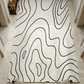 Rug with black wavy lines on a white background