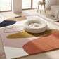 Colorful abstract rug with a round white pet bed in a bright room.