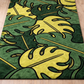 Rug with green and yellow leaf pattern on a wooden floor