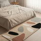 Colorful abstract rug on a wooden floor in a bedroom setting