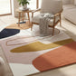 Modern living room with a colorful abstract rug, chair, and side table.