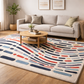 Living room with a colorful rug, sofa, and coffee table.