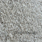 A close-up of a textured rug with a glazed sand look
