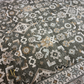 Close-up of a patterned rug with geometric and floral designs.