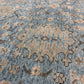 Close-up of a patterned rug with blue and beige colors