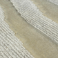A close-up of a luxurious rug with silky wave motifs