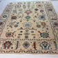 Decorative rug with intricate patterns on a white floor