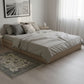 Neatly made bed in a modern bedroom with light decor