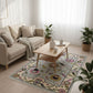 Living room with a beige sofa, coffee table, and decorative rug.