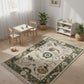 Children's playroom with a patterned rug, table, chairs, and toys.
