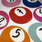 Colorful circular patterns with numbers and letters on a textured surface