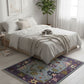 Bedroom with a colorful rug on the floor, bed with white bedding, and a plant in the corner.