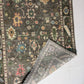 Two patterned rugs on a white floor, one larger and more detailed, the other smaller and simpler.