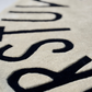 Beige patterned Alphabetical rug on a floor