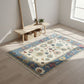 Decorative rug with floral pattern on a wooden floor in a bright room.
