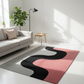Modern living room with a colorful abstract rug on a white floor.