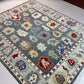 Decorative rug with colorful floral patterns on a white floor.