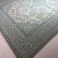 Patterned rug on a tiled floor
