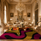 A luxury living room featuring a large area rug with bold, wavy abstract patterns in magenta, yellow, black, and orange. The room is styled in an elegant, classic French chateau aesthetic with gold-trimmed walls, a large crystal chandelier, and matching cream-colored armchairs.