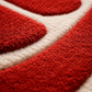 Close-up of a red and white textured rug