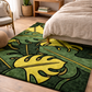 Green and yellow leaf-patterned rug in a bedroom setting with a bed and chair.