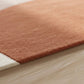 Brown bath mat on a wooden floor