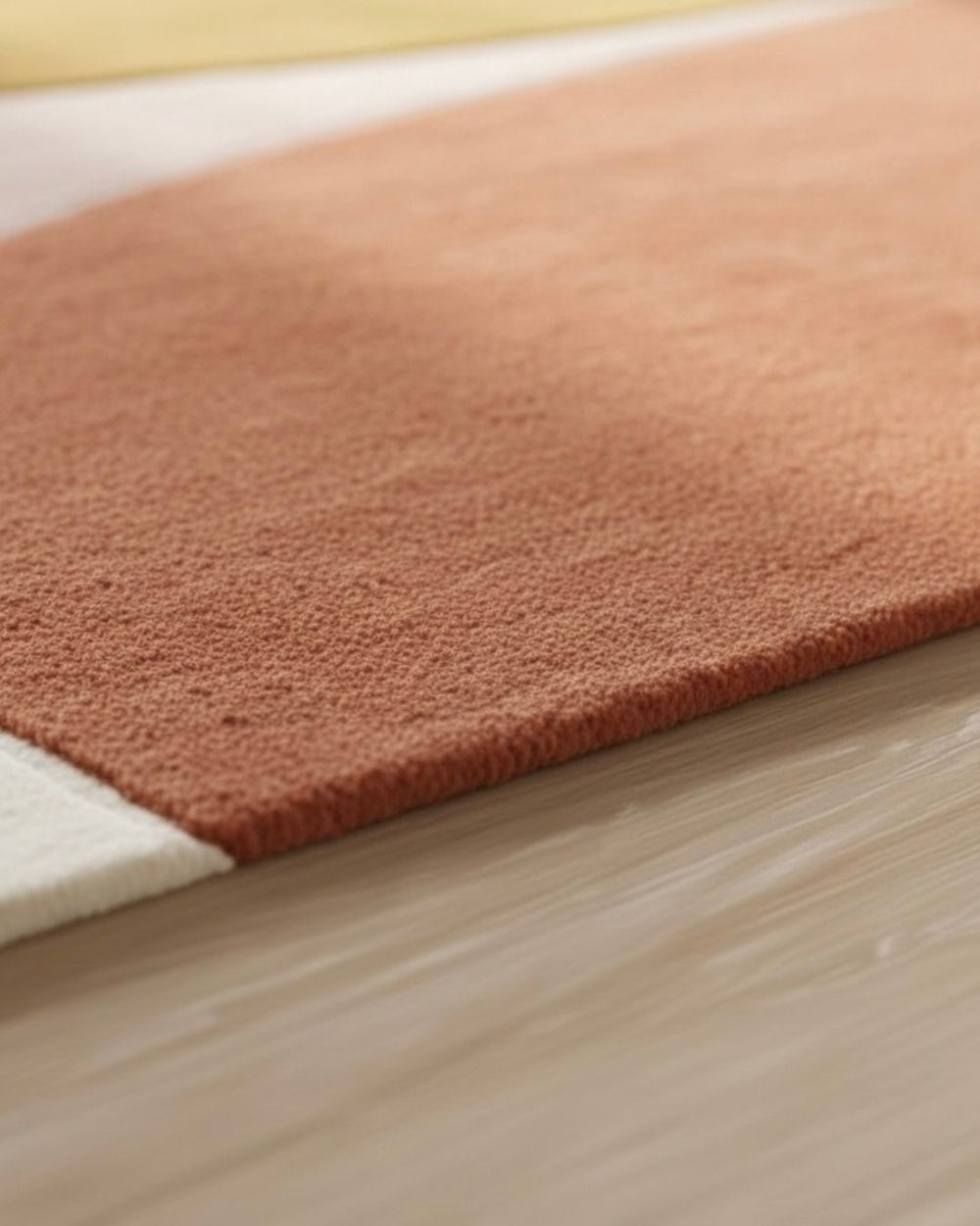 Brown bath mat on a wooden floor