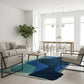 Modern living room with a blue abstract rug, white sofa, and wooden coffee table.
