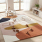 Colorful children's play rug with toys on a light wood floor in a bright room.