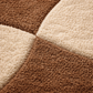 Close-up of a brown and beige checkered patterned rug.