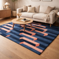 Living room with a geometric patterned rug, beige sofa, and wooden coffee table.