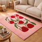 Pink rug with red tulip design in a living room setting