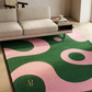 Living room with a colorful abstract rug and beige sofa.