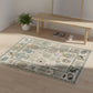 Decorative rug with animal patterns on a wooden floor, with a bench and mirror in the background.