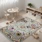 Children's playroom with a floral rug, wooden toys, and furniture.