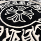 Close-up of a black and white decorative design with intricate patterns and text.