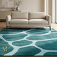 Beige sofa in a living room with a teal patterned rug