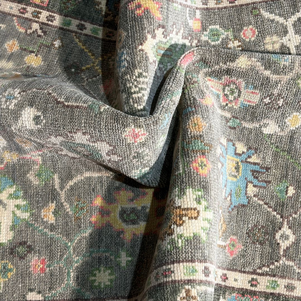 Close-up of patterned fabric with intricate designs in various colors.