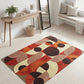Geometric patterned rug on a light wooden floor with a minimalistic decor.