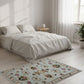 Bedroom with a floral rug in front of a bed