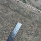 Gray textured rug with a ruler for scale