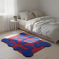 Modern bedroom with a colorful abstract rug on the floor.