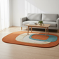 Living room with a colorful oval rug, gray sofa, and wooden coffee table.
